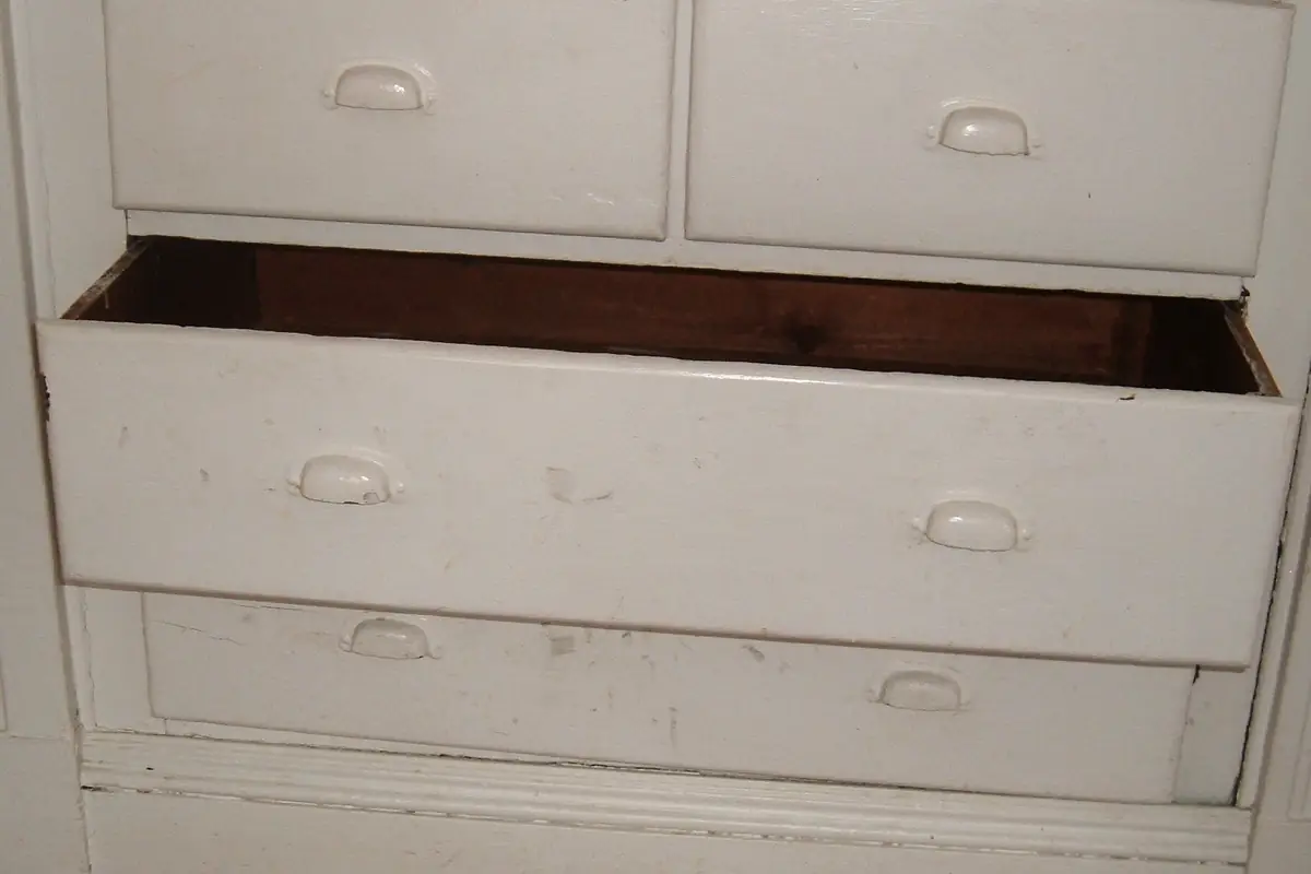 A drawer box pulled out of a cabinet showing the corner joinery and the base panel