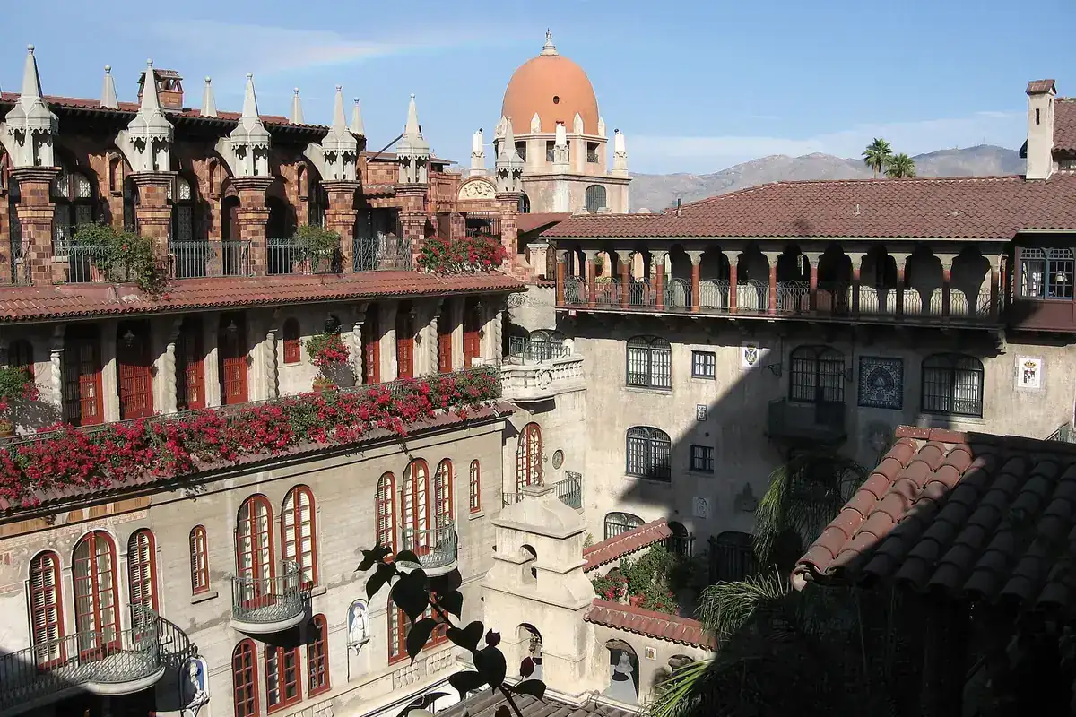 The Mission Inn in Riverside California, a Mission Revival building with arcades, a tiled dome and bougainvillea