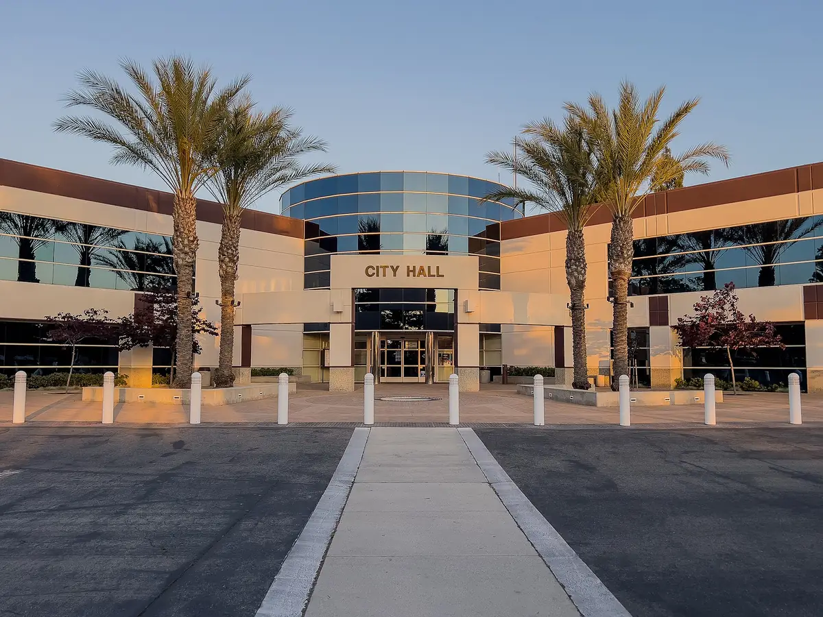 Moreno Valley City Hall in California, a low modern civic building with palm trees in front of it
