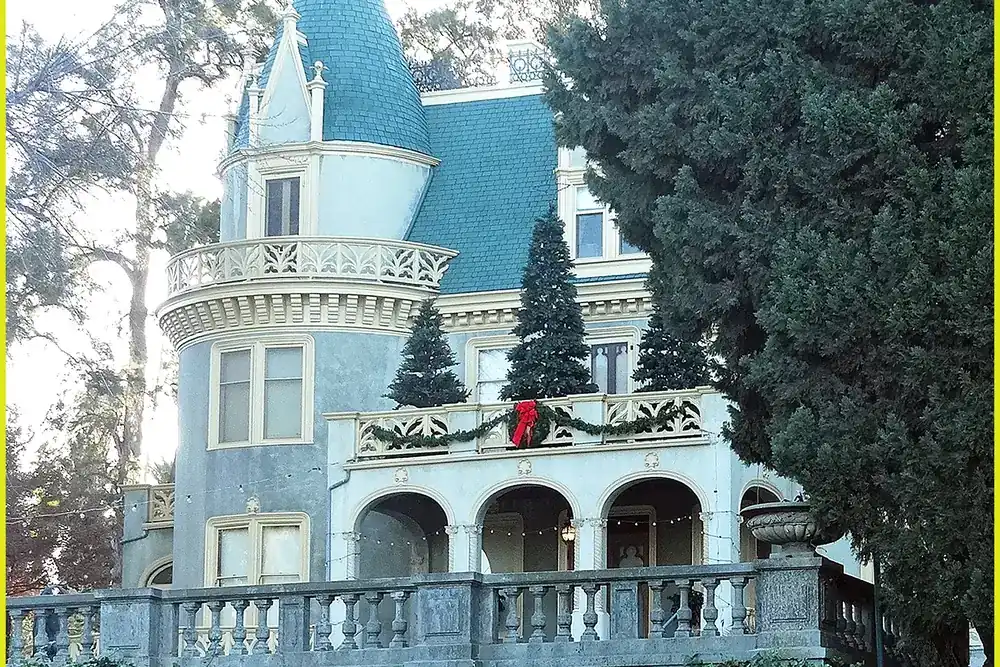 Kimberly Crest house in Redlands California, a Victorian mansion with a turret, steep roof and an arched terrace with balustrades