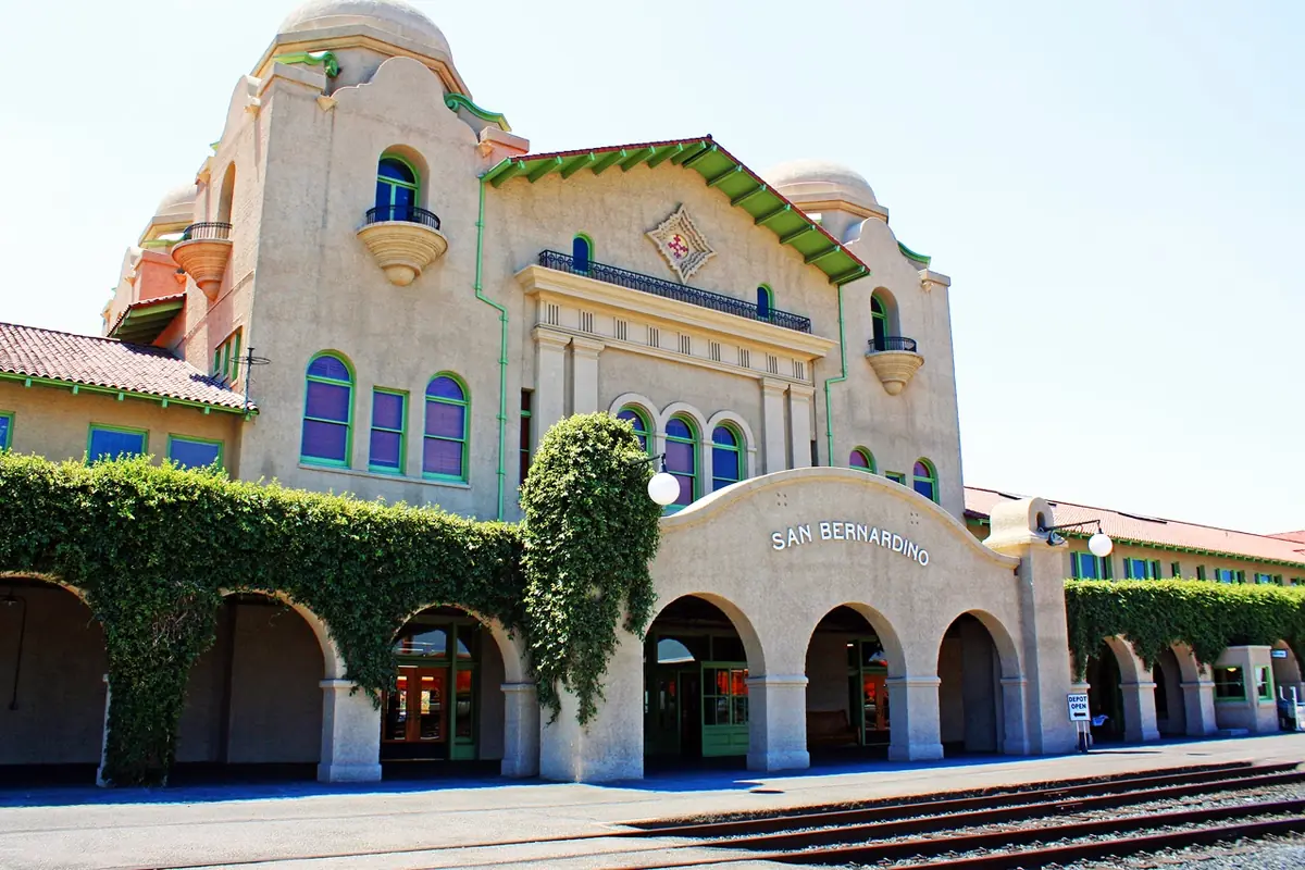 The Santa Fe depot in San Bernardino California, a long Mission Revival railway station with arcades, towers and tiled roofs